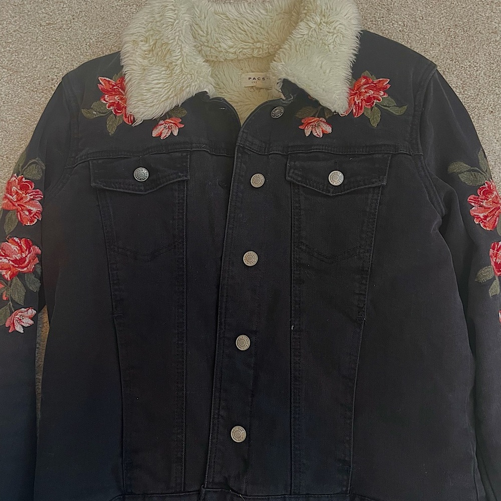 Black denim jacket with faux fur lining and floral patch work.